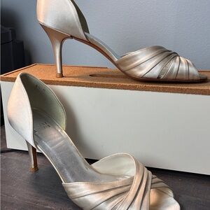 Stuart Weitzman metallic satin peep-toe d'orsay pumps.